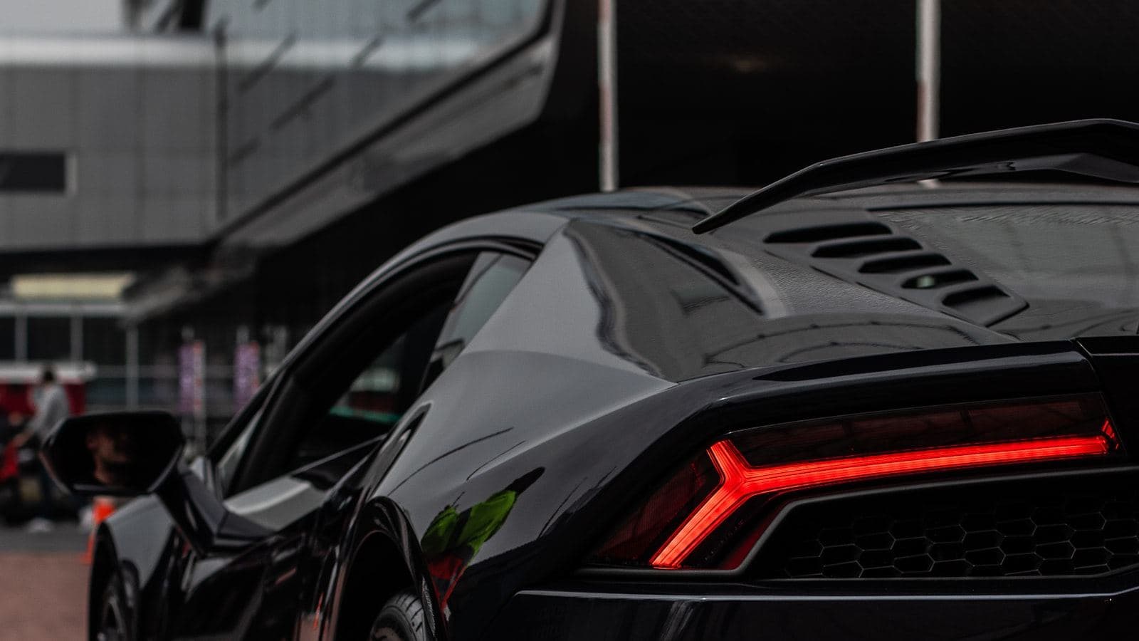 Black-and-red Ferrari supercar in a showroom setting